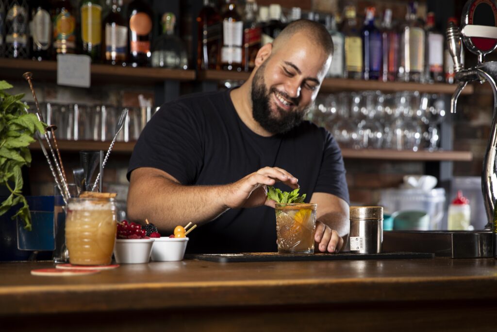 close-up-bartender-creating-delicious-drink