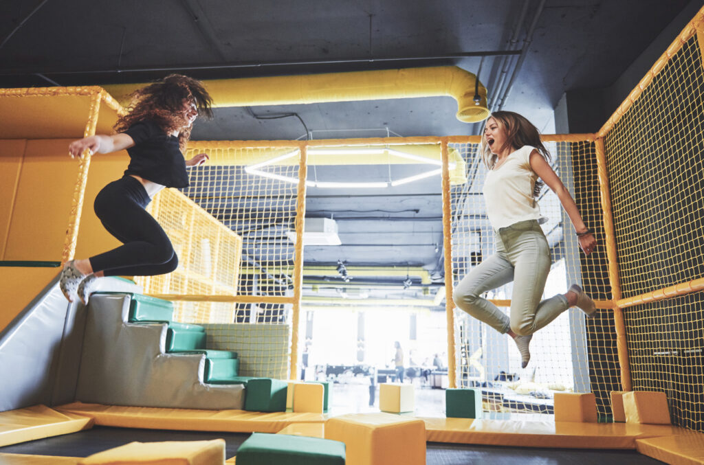 The company is a young woman who has fun with soft blocks on a children’s playground in a trampoline center.