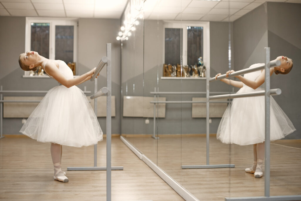 Ballerina posing in front of white background