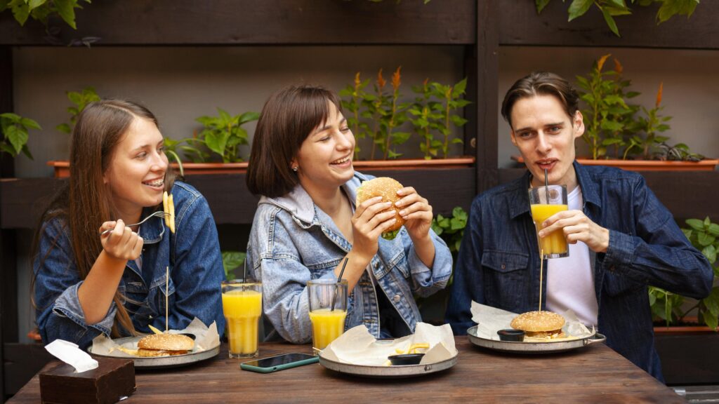 group-three-friends-eating-burgers