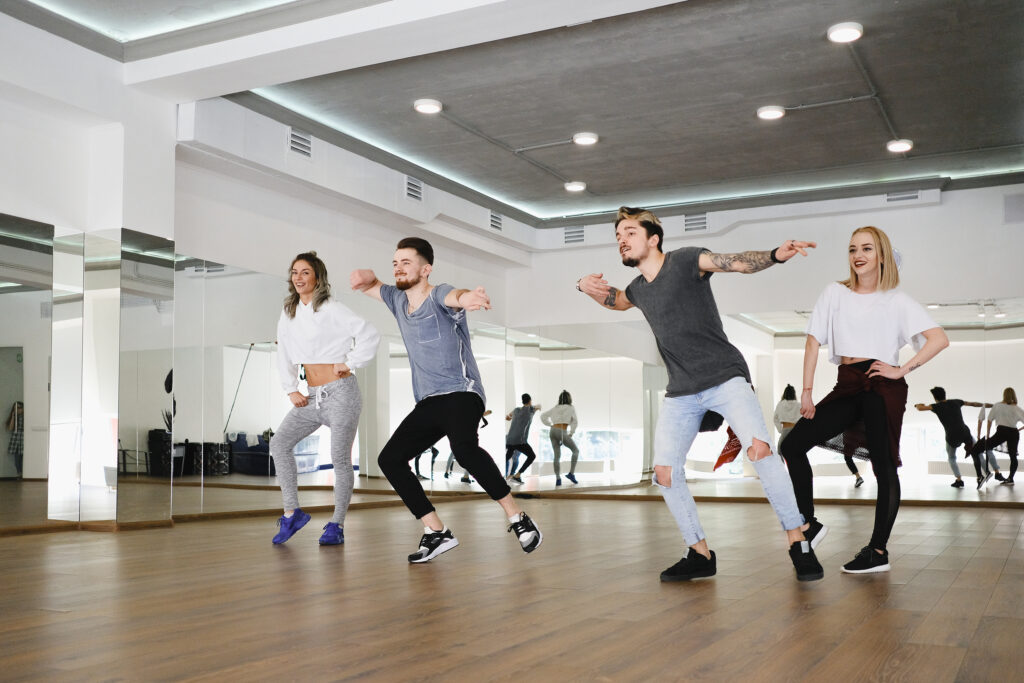 Group of young modern dancers dancing in the studio