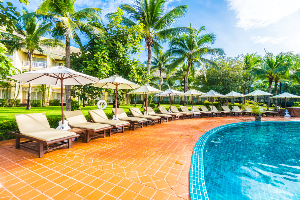 Umbrella and chair around swimming pool