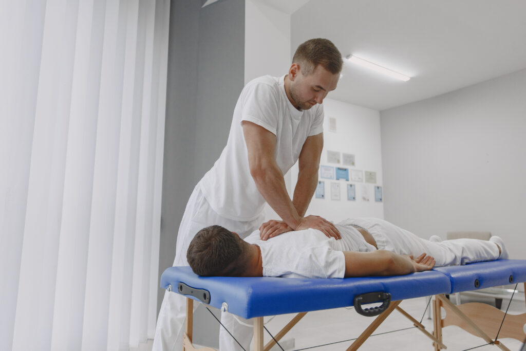 Male physiotherapist massaging man’s back