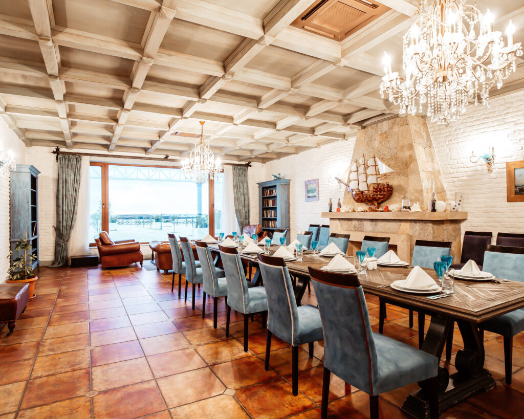 restaurant private room_ with blue chairs white walls fireplace and wide window