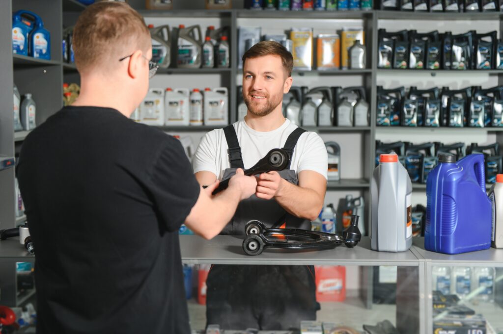The seller selects new car repair parts for the client