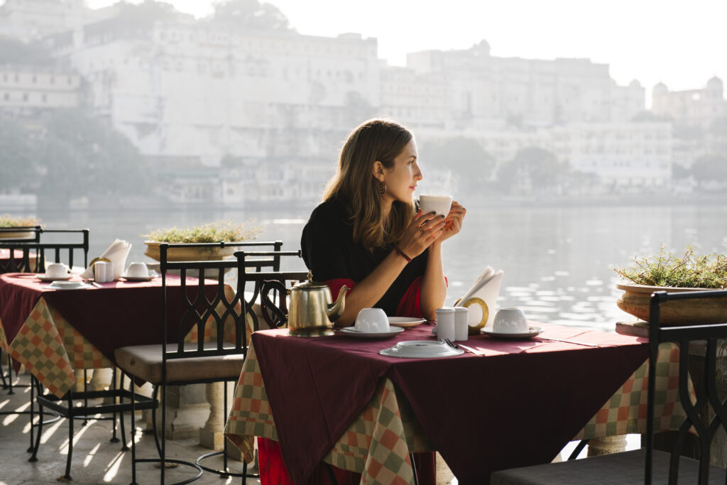 Western woman having a teatime at a cafe in Udaipur