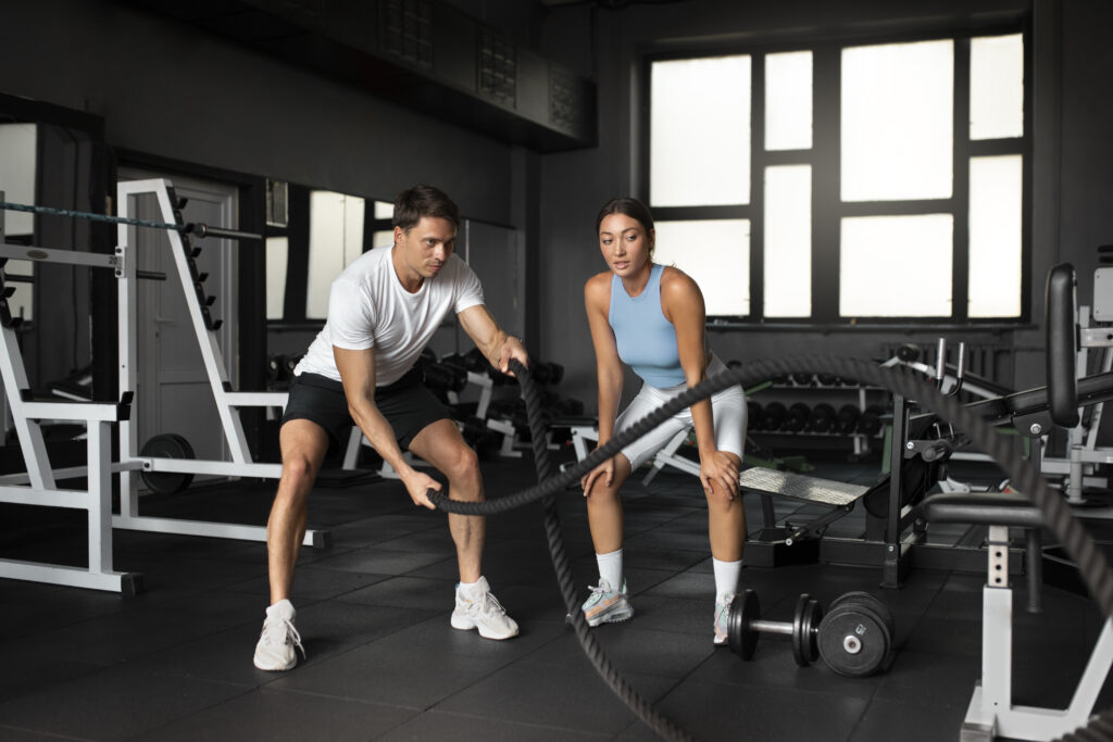 woman-helping-man-gym